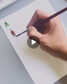 someone is drawing on paper with a pencil