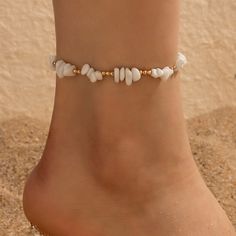 Embrace Your Bohemian Spirit Step into the warm embrace of summer with our Boho Shell Charm and Crushed Stone Anklet Set. Perfectly crafted to enhance your beach attire, this set of anklets brings a touch of bohemian elegance to any outfit. Whether you're strolling along the seashore or dancing under the stars, these anklets add a fashionable flair that celebrates your free-spirited style. Product Features Each anklet in this set is a showcase of thoughtful design and craftsmanship. Made with a tin alloy base, these pieces are adorned with charming geometric patterns and embellished with natural shell pieces and crushed stones, giving each piece a unique, artisanal feel. The anklets measure 20cm in length, ensuring a comfortable fit for all. Material: Durable metal with a tin alloy base St Trendy Handmade Anklets For Spring, Handmade Trendy Anklets For Spring, Summer Beach Anklet With Ankle Wrap, Gold Beachy Bracelets For Summer, Bohemian Bracelets For Spring, Adjustable White Anklets For Spring, Handmade White Anklets For Summer, White Ankle Wrap Anklets For Beach, Adjustable Anklets For Summer Gift