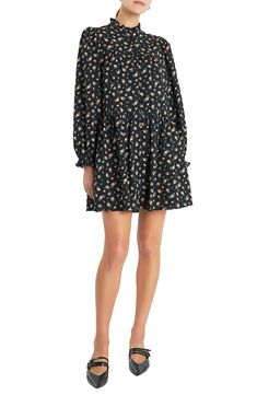 A charming floral print adorns a long-sleeve babydoll dress fashioned with a ruffled mock neck and tiered silhouette. 35 1/2" length Front button closure Mock neck Long sleeves with elastic cuffs Lined 100% polyester Hand wash, line dry Imported Black Long Sleeve Dress With Floral Print, Long Sleeve Ditsy Floral Dress For Spring, Casual Floral Long Sleeve Dress With Ruffle Hem, Casual Long Sleeve Floral Dress With Ruffle Hem, Printed Long Sleeve Relaxed Fit Dress, Fall Daywear Long Sleeve Mini Dress, Casual Long Sleeve Ditsy Floral Dress, Fall Mini Length Long Sleeve Dress For Daywear, Fall Long Sleeve Mini Dress For Daywear