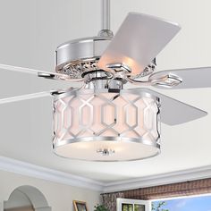 a ceiling fan that is hanging from the ceiling in a room with white walls and windows