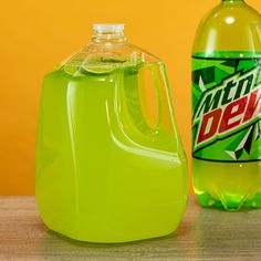 a bottle of mountain dew next to a plastic jug