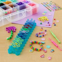 plastic beads, scissors and other crafting supplies on a table