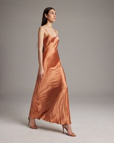 Named by Vogue as a must-have, this easy to wear luxury charmeuse slip dress is the perfect day to night staple. Featuring a bias cut and the finest silk quality, it shapes flatteringly to every type of body. Bias cut silk charmeuse slip elegantly drapes on the body. 100% Silk Charmeuse Made in New York City Model is wearing a size S and is 5'10" Product Care: Dry Clean Only City Model, Silk Dress Long, The Perfect Day, Silk Slip Dress, Boatneck Sweater, Silk Tank, Silk Charmeuse, Silk Slip, Perfect Day