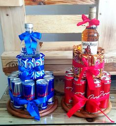 two wooden trays with bottles and cans on them, one has a red ribbon around it