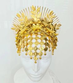 This headpiece is made of bright yellow gold metal parts (a bit warmer gold than in the pictures). It includes a forehead net with coins and tiny bells, and a 3D flower arrangement with spikes and leaf branches above it. It sits on a wide headband and will have an elastic connecting its edges unless you prefer not to have it. The headdress is quite shiny due to the golden colour of the metal, but additional accents canbe created by crystal application (including Swarovski crystals - please conta Gold Structured Crown Headpiece For Festival, Gold Round Crown Headpiece For Weddings, Gold Wedding Headpiece With Round Crown, Gold Teardrop Crown Headpiece For Festival, Gold Tall Crown Headpiece Handmade, Gold Structured Crown Fantasy Headpiece, Gold Fantasy Headpiece With Structured Crown, Gold Crown Costume Headpiece For Weddings, Elegant Gold Costume Hats And Headpieces For Ceremonial