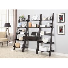 a ladder shelf with bookshelves and pictures on it