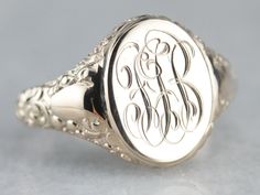 "We've created this lovely ornate piece, from two antique components creating one lovely statement piece! An antique oval top with scrolling \"FGB\" initials in French script has been soldered atop an antique mounting with ornate motifs along its shoulders. The lovely monogram of this signet ring is so beautifully engraved and entwined that it makes a lovely image, regardless of their initials! Please note that this signet ring has its original monogram, unfortunately, this piece cannot be alter Yellow Gold Sapphire Ring, 10 Marks, French Script, Gold Statement Ring, Top Measurements, Cameo Ring, Gold Signet Ring, Gold Top, July Birthstone