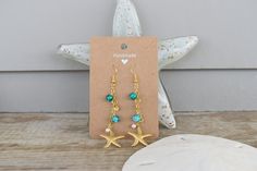 These beachy dangle earrings are handmade and hand assembled with beachy vibes in mind!  The material is delicate and should not be worn in water or with oils and lotions! Beach Wire Wrapped Drop Earrings, Handmade Dangle Earrings For Beach Season, Handmade Beachy Earrings For Gift, Handmade Beachy Earrings As Gift, Handmade Ocean Color Jewelry For Summer, Gold Dangle Earrings For Beach Season, Handmade Ocean Color Summer Jewelry, Summer Starfish Charm Dangle Earrings, Summer Dangle Earrings With Starfish Charm