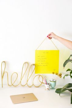 a desk with a yellow sign hanging from it's side