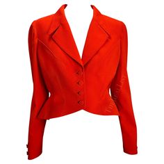 Presenting a fabulous bright orange Thierry Mugler blazer designed by Manfred Mugler. From the 1980s, this jacket features masterful craftsmanship and design. Mugler was known for his exaggerated silhouettes; this jacket was no exception. From the heydays of Mugler's namesake brand, this jacket is a must-have addition to any wardrobe! Approximate measurements: Size - 40FR Shoulder to hem: 18" Bust: 37" Waist: 30" Shoulder to cuff: 25" Underarm to cuff: 18" 100% Worsted Wool Vintage Red Party Blazer, Mugler Blazer, Orange Blazer, Blazer Designs, Thierry Mugler, Red Blazer, Cropped Blazer, The 1980s, Bright Orange