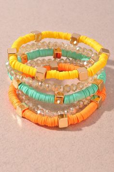 three different colored bracelets sitting on top of a table