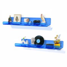 two blue shelves with vinyl records and other items on them, each shelf has a record