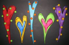 four different colored flowers on a blackboard with polka dots and green, red, blue, yellow, orange