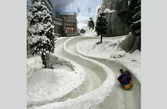 a person is sledding down a hill in the snow