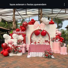 a table with red and white balloons on it