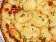 a baked dish with potatoes and herbs on top