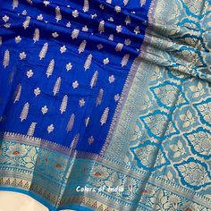 Blue saree blouse  , Georgette saree with zari borders , Semi georgette sarees for women , FREE SHIPPING This is a handwoven semi  georgette saree in  beautiful eye catching  colors . Each saree  comes with zari butis all over the body ,  floral zari borders on both the sides  and a very heavily embroidered  pallu . All the sarees come with  an unstitched blouse piece .  MATERIAL : Semi  Georgette  MEASUREMENTS : Width of the Saree :  44  Inches  Length of the Saree :  5.50 meters  Matching  Blo Blue Chanderi Pre-draped Saree With Motifs, Blue Katan Silk Pre-draped Saree With Zari Work, Blue Dola Silk Pre-draped Saree With Zari Weaving, Blue Katan Silk Saree With Zari Work, Blue Saree With Zari Work, Blue Katan Silk Saree For Festive Occasion, Blue Salwar Kameez With Unstitched Blouse, Blue Katan Silk Dupatta For Navratri, Blue Bollywood Banarasi Silk Pre-draped Saree