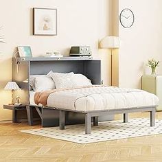 a bed sitting in the middle of a wooden floor next to a wall mounted clock