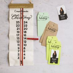 some tags are hanging on a wall next to a ruler and other items that have been placed around them