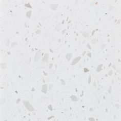 a white marble floor with small pieces of glass on it