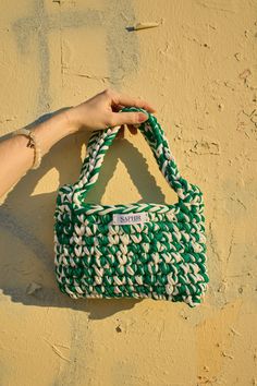 Your truly unique crochet bag handcrafted from eco friendly materials, 100% recycled cotton. This chic accessory is designed to hold your must-haves while adding a touch of charm to any outfit. Whether you're heading to a casual lunch, a night out, or running errands, this mini bag will elevate your style with ease. Sizes 25x15 sm. Hand Wash Only. Casual Green Crochet Bag With Adjustable Strap, Casual Green Crochet Shoulder Bag, Handmade Green Crochet Shoulder Bag, Casual Green Hand-knitted Crochet Bag, Eco-friendly Green Handwoven Shoulder Bag, Chic Accessories, Unique Crochet, Crochet Handbags, Recycled Cotton