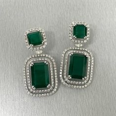 The Renee Emerald & Diamond Earrings are a unique and luxurious heritage pair with royal green emeralds and diamonds set in white gold. Gemstones Type: EmeraldGemstones Shape: RectangularGemstones Weight: 25.01 ctGemstones Color: Green Diamonds Shapes: Round & Marquise Total Diamonds Weight: 3.01 ctDiamonds Color: H - J Diamonds Clarity: VS - SI (Very Slightly Included - Slightly Included) Metal: 14K Gold Metal Wt: 17.4 gms Setting: Prong Set Price Quoted may be negotiable. Please contact us to Luxury Green Diamond Earrings, Luxury Green Emerald Diamond Earrings, Formal Green Diamond Gemstone Earrings, Green Diamond Earrings With 17 Jewels For Formal Events, Green Diamond Earrings With 17 Jewels For Formal Occasions, Formal Green Gemstone Diamond Earrings, Luxury Green Diamond Earrings For Wedding, Green Hand Set Diamond Earrings, Green Hand-set Diamond Earrings