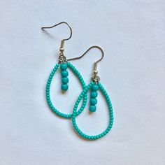 These handmade, beaded teardrop shaped earrings come in a variety of colors. this pair is A teal turquoise color. Perfect for all occasions and super comfortable to wear. These earrings are not heavy at all and can be worn comfortably all day. The earrings are 2 cm across. Every pair is unique and  may look somewhat different than the picture. I love making these earrings and hope you enjoy wearing them! Turquoise Teardrop Earrings With Tiny Beads, Turquoise Teardrop Beaded Earrings As Gift, Turquoise Teardrop Beaded Earrings For Gifts, Bohemian Turquoise Teardrop Beaded Earrings, Turquoise Teardrop Beaded Bohemian Earrings, Turquoise Bohemian Beaded Teardrop Earrings, Blue Teardrop Earrings With Dangling Beads, Turquoise Teardrop Drop Earrings With Ear Wire, Turquoise Teardrop Drop Earrings