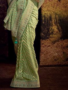 Create your occasional look more impressive by enrobing yourself in this stunning green Banglory silk party wear saree with a blouse. Crafted with precision and elegance, this saree is truly a masterpiece that will make you stand out at any event or party.
Firstly, it is made of high-quality Banglory silk fabric, ensuring a comfortable and luxurious feel against your skin. The stunning green color adds a touch of vibrancy and freshness to your overall look, making you the center of attention whe Green Tussar Silk Pre-draped Saree, Festive Green Chanderi Pre-draped Saree, Green Pre-draped Saree With Traditional Drape, Festive Pista Green Banarasi Silk Pre-draped Saree, Green Bollywood Pre-draped Saree With Meenakari, Festive Green Pre-draped Saree With Pallu, Green Semi-stitched Pre-draped Saree With Meenakari, Green Anarkali Pre-draped Saree In Raw Silk, Green Chanderi Pre-draped Saree For Diwali