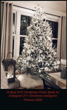 a white christmas tree sitting in front of a window