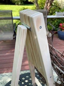 a wooden easel sitting on top of a patio