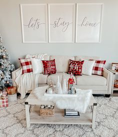 a living room decorated for christmas with red and white decor