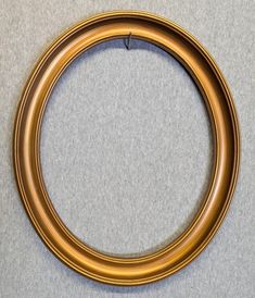 a gold colored metal ring on a gray surface