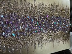 an abstract painting with purple and silver crystals