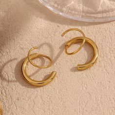 Create a unique look with our Twisted Hoop Earrings! These versatile earrings give the appearance of a double piercing, making them perfect for everyday wear. With their cute and stylish design, you'll be sure to turn heads. Elevate your style with these must-have earrings. 18K Gold Plated over 316L Stainless Hypoallergenic, waterproof, tarnish free. Made to last. Double Piercing, Twisted Hoop Earrings, Jewelry Care Instructions, Faux Mink Lashes, Steel Earrings, Stone Collection, Stainless Steel Earrings, Gold Plated Jewelry, Ring Bracelet