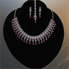 American diamond CZ Green,white and ruby stone studded rhodium plated bridal jewelry. Indian Bollywood style AD necklace, earrings and Tikka makes makes the perfect gifts for bridesmaids,Wife, Mother, Sister or Gift for Loved ones. Total length of the necklace + length of the extender is 17 inches. Length of Earring is 1.5 inches. Best suitable for Party Wear / Fashion Wear for Any Occasion. Care Instructions: We recommend avoiding direct exposure to fragrances. Pink Jewelry Sets With Sparkling Stones For Wedding, Pink Diamond Bridal Earrings For Wedding, Silver Bridal Necklace With Round Ruby, Silver Ruby Bridal Necklace, Round Shape, Silver Bridal Necklace With Ruby Accents, Ruby Jewelry Set With Diamond Accents For Wedding, Pink Diamond Jewelry Sets For Wedding, Pink Diamond Wedding Jewelry Set, Red Rhinestone Wedding Jewelry