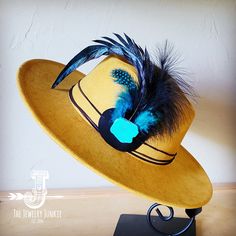 If you’re looking for the perfect accessory to complement your favorite boho style, look no further. This Boho-Style Western Felt Hat w/ Natural Feather & Turquoise Hat Accent by The Jewelry Junkie is absolutely everything that you need. Not only is it easy to incorporate into any and all outfits, but the genuine leather and natural feathers of the band immediately elevate whatever it is you’re wearing. One Size Hat with adjustable inner hat liner (see last photos) The same primary feathers will Adjustable Feather Hat Bands For Western-themed Events, Handmade Turquoise Hat, One Size Fits Most, Turquoise Fedora Hat For Western-themed Events, Bohemian Felt Hat With Feathers For Western-themed Events, Southwestern Turquoise Brimmed Hat, Turquoise Hat, Western Hat, Couture Hats, Leather Hat