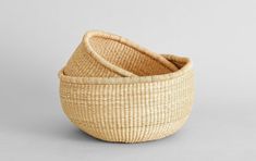 two woven baskets sitting next to each other