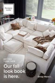 a large white sectional couch in front of a window