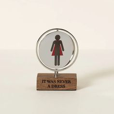 a glass and wood stand with an image of a woman in a red dress on it