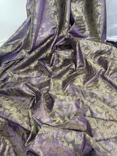 "TWO TONE DARK PURPLE/GOLD PAISLEY SELF PRINT JACQUARD FABRIC Product information 1 mtr two tone dark purple/gold paisley jacquard fabric. This is self print jacquard fabric 58\" wide 147cm Jacquard fabric is highly textured fabric with patterns that are woven, rather than printed into the fabric. Jacquard fabrics have a raised pattern design that may include floral,paisleys,damask and animal patterns. Ideally used for decorations,dress making,bridal,,dress lining,waistcoats,jackets,table runners,crafts, drapery,decorations and many other projects Sold by the mtr If more than one quantity is bought it will be sent as one continous length" Purple And Gold African Fabric, Purple And Gold Dress, Gold Paisley, Bridal Fabric, Animal Patterns, Metal Lace, Brocade Fabric, Paisley Design, Metallic Blue