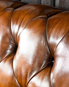 a close up view of a brown leather couch