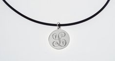 This elegant necklace is sure to bring you many compliments !  I will carefully engrave a single, beautifully ornate script initial on this high polish 7/8" diameter sterling silver disc.  Take a look at the last picture - I have engraved a sample of each letter, so you can see what yours will look like! This lovely necklace is suitable for every day wear or formal events.The finished piece will be suspended on your choice of:*16" rubber cord with stainless steel lobster clasp or*18" rubber cord Symbolic Stamped Necklace For Anniversary, Elegant Stainless Steel Medallion Necklace, Engraved Stainless Steel Jewelry With Initial Pendant, Symbolic Medallion Necklace With Engraving Option, Engraved Stainless Steel Medallion Jewelry, Symbolic Engraved Round Pendant Jewelry, Symbolic Silver Necklace With Laser Engraving, Symbolic Silver Jewelry With Laser Engraving, Symbolic Silver Laser Engraved Jewelry