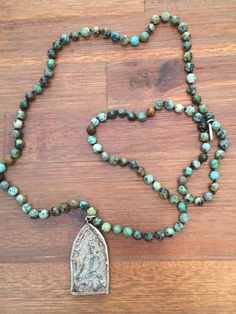 This African Turquoise Beaded Buddha Mala Necklace is exquisite quality!Handmade beaded African Turquoise prayer beads meditation necklace. This lovely pendant is made in Thailand from a mold patterned after an antique mold that has been used for making sacred amulets for over 500 years.  Beads are 6mm and the pendant is 2 inches long 1 inch wide. Adjustable Beaded Turquoise Necklace For Meditation, Turquoise Spiritual Beads For Meditation, Spiritual Turquoise Beads For Meditation, Adjustable Spiritual Turquoise Necklace For Meditation, Spiritual Turquoise Necklace With Round Beads For Meditation, Spiritual Turquoise Necklace With Round Beads For Healing, Bohemian Beaded Turquoise Necklace For Meditation, Turquoise Spiritual Necklaces With 8mm Beads, Spiritual Turquoise Necklace With 8mm Beads