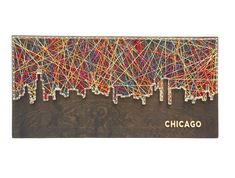 the san francisco skyline is made out of string and wood with red, green, yellow, and blue lines