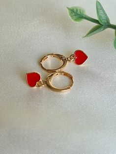 ❤Gorgeous little pair of handmade heart 18K Gold plated huggie hoop earrings. ❤The little red enamel heart is just 8mmx7mm       and the long lasting 18K Gold plated huggies are a cute 12mm in diameter.   ❤Hypoallergenic and great for sensitive ears.  ❤ Perfect huggies for everyday wear or a gift for that someone special. They will arrive in a lovely velvet pouch ready for gifting 🎁  Note colours may vary due to individual monitors but please contact me with any queries.  Thanks for checking ou Affordable Huggie Heart Earrings As A Gift, Small Hoop Heart Earrings For Valentine's Day Gift, Valentine's Day Small Hoop Heart Earrings As Gift, Trendy Hoop Earrings With Heart Charm For Gift, Cute Huggie Jewelry For Valentine's Day, Valentine's Day Gift Small Hoop Heart Earrings, Trendy Heart Charm Earrings As Gift, Trendy Double Heart Earrings As Gift, Dainty 14k Gold Filled Huggie Earrings For Gift