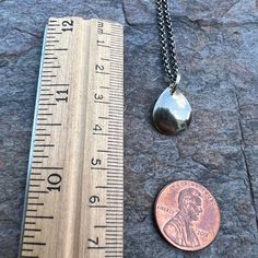 A small simple teardrop has been cut from a sheet of pure sterling silver. The teardrop was then slightly domed to give it a rounded shape. Pendant hangs from a sterling silver 1.75mm chain. The end of the chain features a lobster claw clasp and a 3-inch extender chain allowing the necklace to be slightly adjustable in length.Be sure to see all photos and video for size and color reference. Teardrop measures about 12x15mm Select your desired finish and length when ordering. The necklace is shown Color Reference, Lobster Claws, Teardrop Necklace, Handmade Sterling Silver, Sterling Silver Pendant, Matching Earrings, Lobster Claw, Sterling Silver Chains, Handmade Necklaces