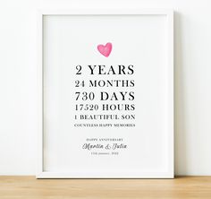 a white framed poster with a pink heart on it's back and the words twenty years