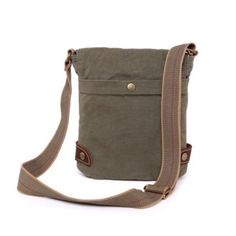 The Oak Hill Crossbody Bag merges rugged outdoor style with modern aesthetics, handcrafted from high-quality cotton canvas and genuine leather. This durable yet elegant bag features 100% recycled nickel-free hardware and eco-friendly vegetable-based dyes, reflecting a commitment to sustainability. It offers practical design with adjustable straps, secure closures, and multiple pockets for easy organization. | TSD Brand Oak Hill Crossbody, Green Khaki Cotton Bag With Adjustable Strap, Casual Duck Canvas Bags With Pockets, Casual Duck Canvas Shoulder Bag With Canvas Lining, Green Canvas Bag With Zipper Pocket, Outdoor Canvas Shoulder Bag With Zipper Pocket, Casual Duck Canvas Shoulder Bag, Green Canvas Bag For Outdoor, Khaki Cotton Bags With Leather Handles, Khaki Duck Canvas Bag With Canvas Lining