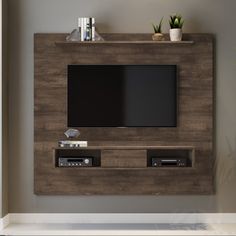 an entertainment center with a flat screen tv mounted on the wall