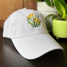 Freesia Flower Hat, Custom Baseball Caps Unwashed with Adjustable Velcro Closure, Embroidered Floral Hats Women, Personalized Mother's Day Gardening Gifts for Her, Yellow Flowers White Dad Hat - CUSTOM TEXT available on the back of cap, above strap opening. - THREAD COLOR (optional): Choose a color for *custom wording on back* & write into personalization box. Default: white or black thread, depending on cap color. - Custom wording on the back of cap will be embroidered according to what dimensi Spring Adjustable Dad Hat With Short Brim, Adjustable Short Brim Dad Hat For Spring, Embroidered Short Brim Baseball Cap, Spring Baseball Cap With Embroidered Logo, Spring Baseball Cap With Embroidered Logo And Short Brim, White Embroidered Dad Cap, White Embroidered Adjustable Dad Hat, Adjustable Brimmed Dad Hat For Spring, Adjustable White Embroidered Dad Hat